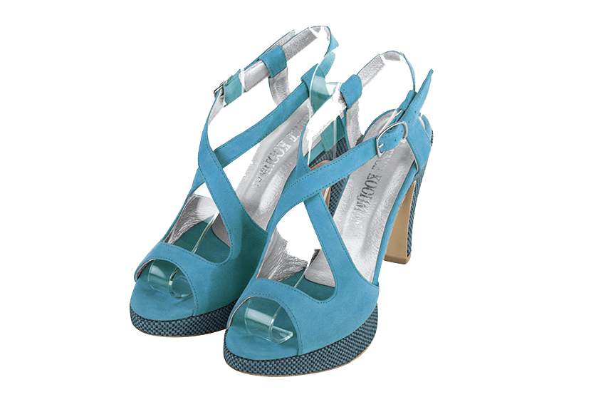 Peacock blue elegant sandals with crossed straps across the instep. Round toe. High slim heel with a platform at the front.